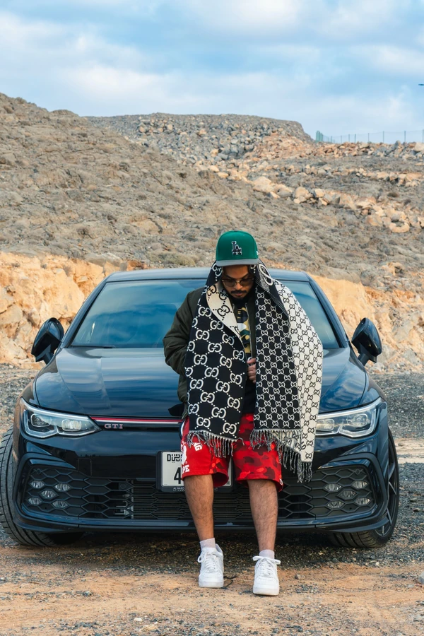 Standing beside a car on a mountain road